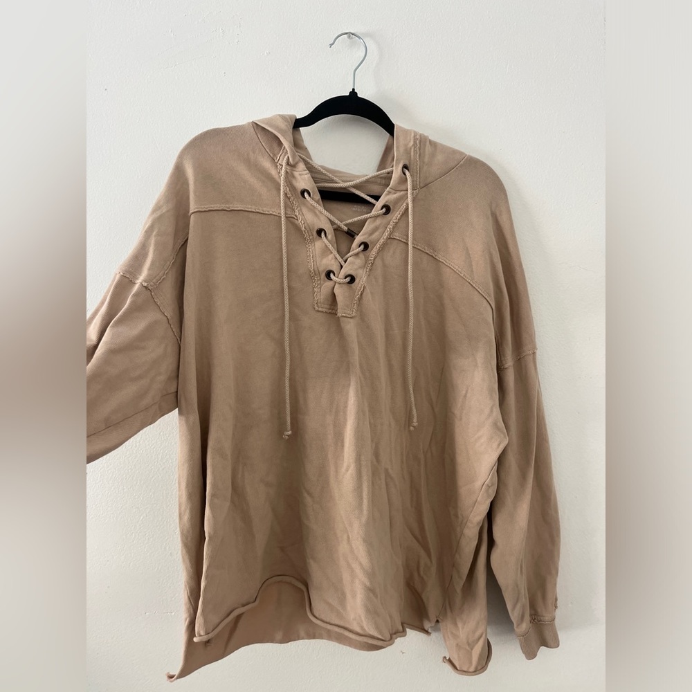 Peachy tan hoodie with crisscross strings from area